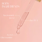 Glass dropper with skincare ingredients on a pink background